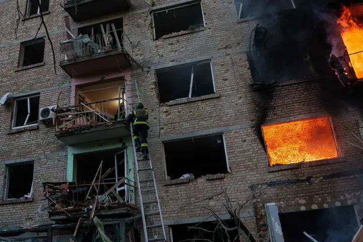 AP A rescue worker climbs on a ladder