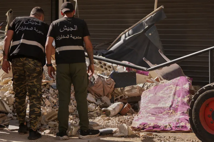 AP Lebanese intelligence officers look at an unexploded missile, centre, at the site where an Israeli airstrike