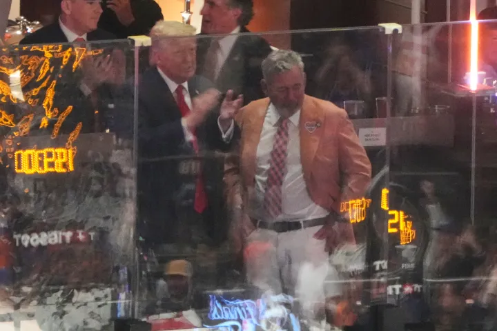 AP President Donald Trump talks with Knicks owner James Dolan