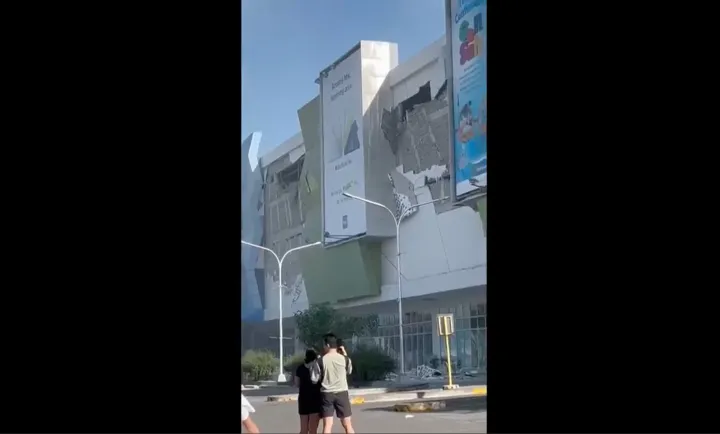 AP This image from a video shows people gathered outside a damaged building