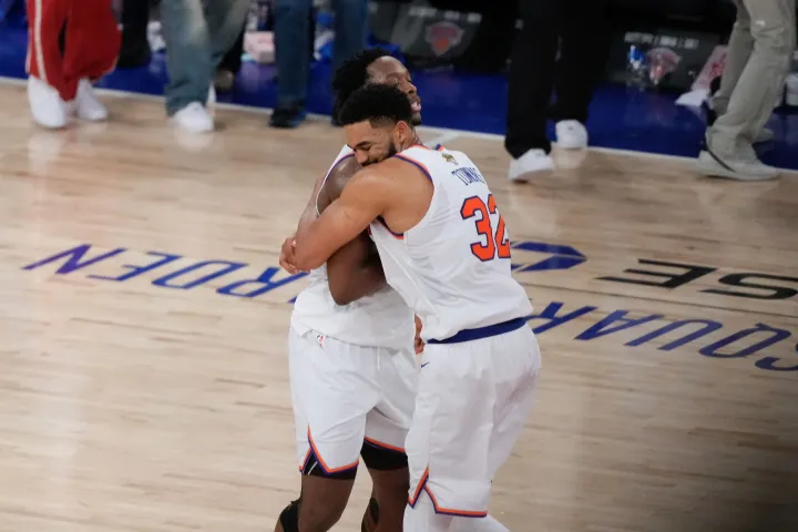 New York Knicks center Karl-Anthony Towns (32) embraces forward Og Anunoby