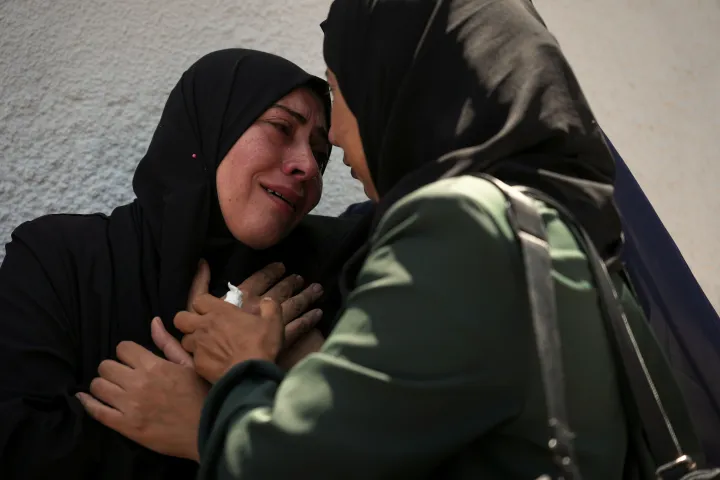 Palestinians attend the funeral of their relatives