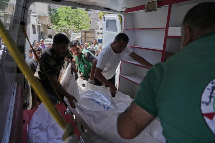 Palestinians carry the bodies of people killed in an Israeli strike