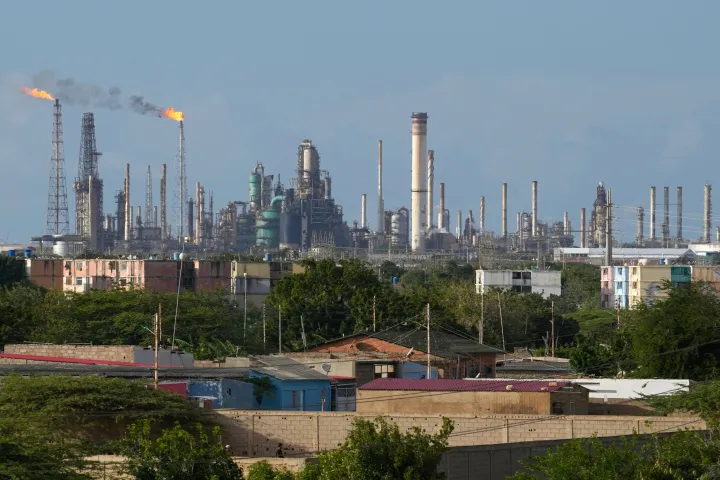 Flames rise from flare stacks at the Amuay refinery in Los Taques, Venezuela