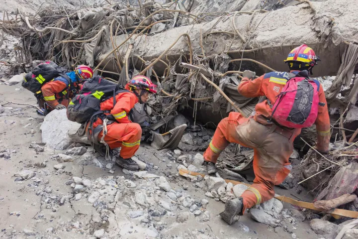 In this photo released by Xinhua News Agency, rescuers carry out search and rescue operations at the mudslide-hit area in Gyirong County, southwest China's Tibet Autonomous Region on Saturday