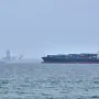 A container ship is seen in the Strait of Hormuz off the coast of Qeshm Island