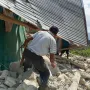 People examine the damage to a house following an earthquake in East Manggarai, East Nusa Tenggara province, Indonesia, Saturday,