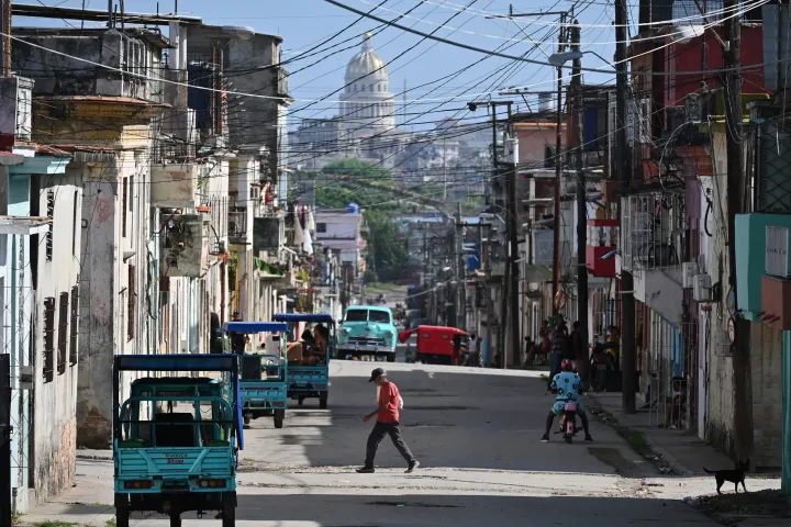 AP A man crosses a street in Havana