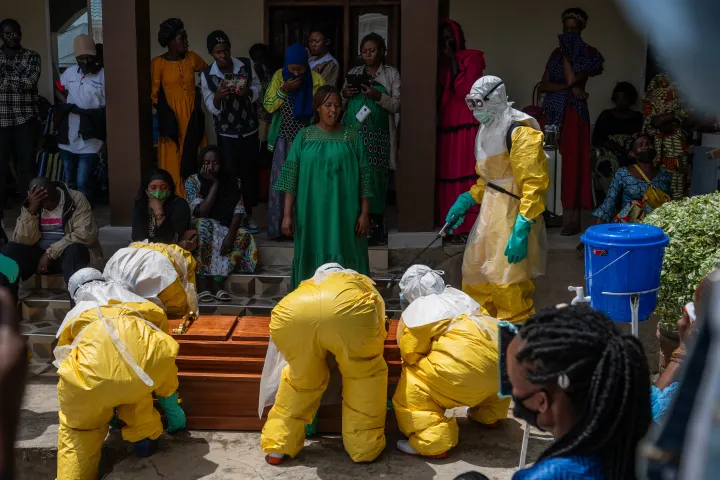 AP Family members of an Ebola victim mourn as the coffin