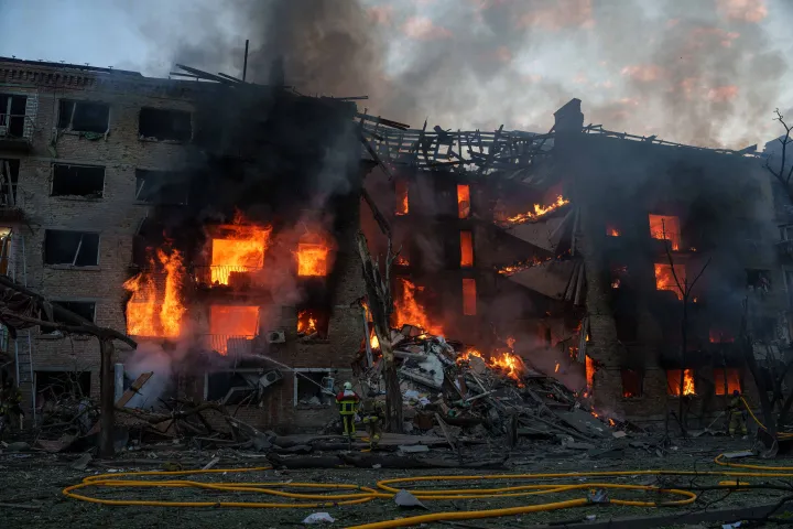 AP Rescue workers try to put out a fire