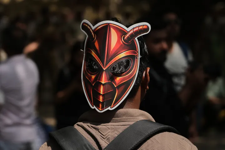AP A participant wears a cockroach mask