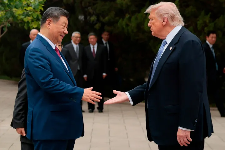 U.S. President Donald Trump, right, shakes hands with Chinese President Xi Jinping 