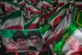 Pro-government Iranian demonstrators wave Iranian flags and a portrait of the Supreme Leader Ayatollah Mojtaba Khamenei