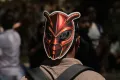 AP A participant wears a cockroach mask