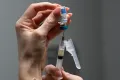 Lauren Ellenburg, a nurse, prepares a combination measle