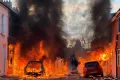AP Vehicles set on fire by protesters burn on Lendrick Street in east Belfast