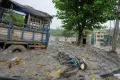 Damaged buildings and vehicles lie in mud and slush caused by flash flooding in Nepal's Nuwakot district