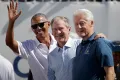 Former U.S. Presidents, from left, Barack Obama, George Bush and Bill Clinton greet spectators on the first tee before the first round of the Presidents Cup at Liberty National Golf Club in Jersey City, N.J.